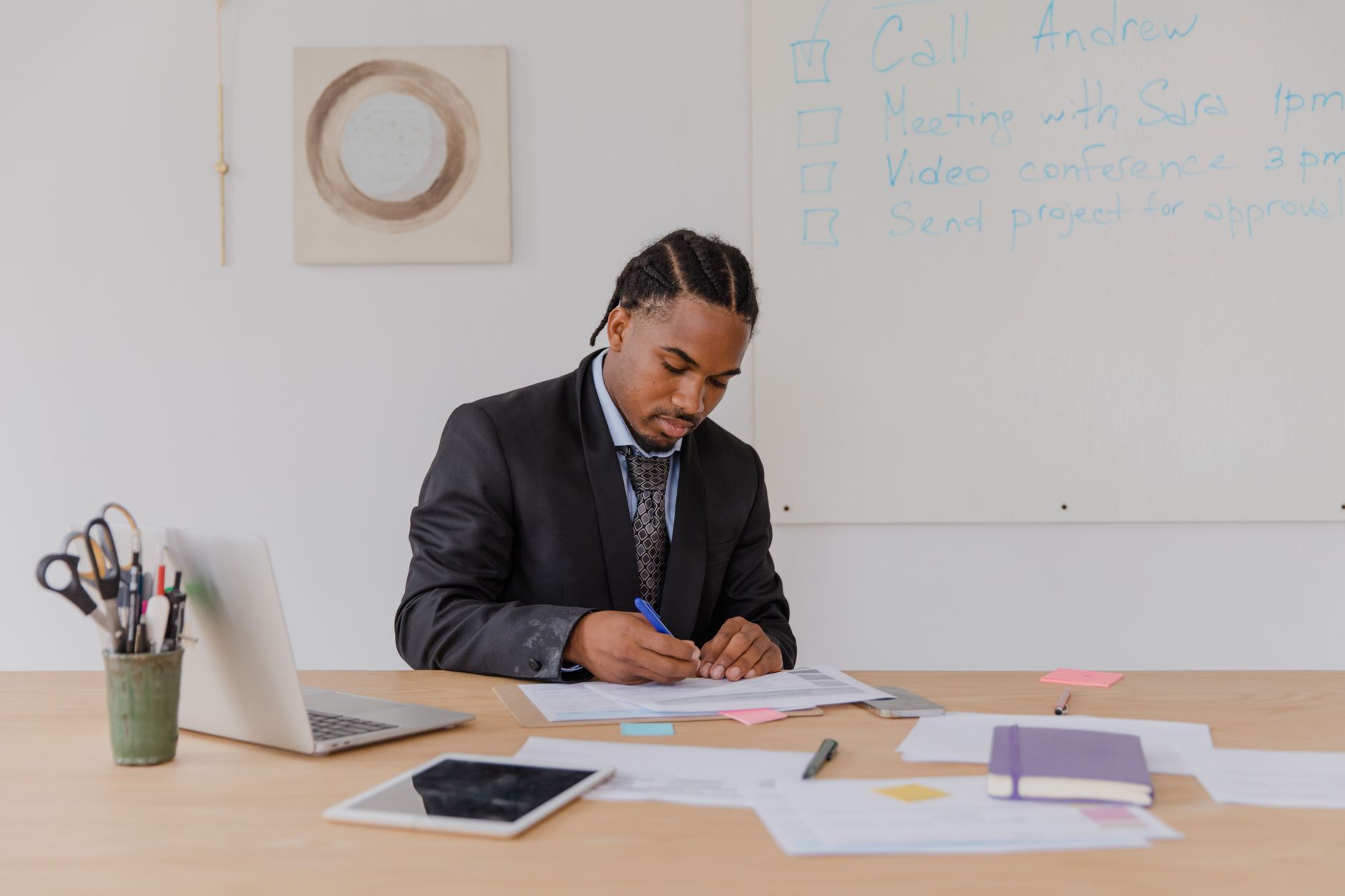 Professional man reviewing documents at his office desk with attention to detail.